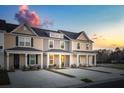 Three townhouses with front porches and parking at sunset at 476 Green Fern Dr, Summerville, SC 29483