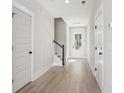 Bright entryway with hardwood floors, staircase, and white doors at 238 Claret Cup Way, Charleston, SC 29414