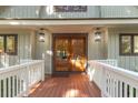 Inviting front entrance with double doors and a wood deck at 202 Needlerush Rd, Kiawah Island, SC 29455