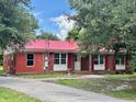 Red brick ranch house with a metal roof and landscaping at 2042 Sniders Highway, Walterboro, SC 29488