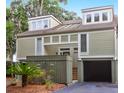 Townhouse with attached garage and lush landscaping at 1720 Live Oak Park, Seabrook Island, SC 29455