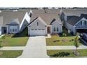 Gray house with white garage door and landscaping in a neighborhood at 253 River Martin Ct, Summerville, SC 29483