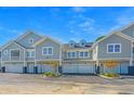 Three-unit townhouse building with attached garages and landscaping at 420 Carolina Cherry Ct # 203, Charleston, SC 29414