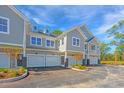 Three-unit townhouse building with attached garages and landscaping at 420 Carolina Cherry Ct # 203, Charleston, SC 29414