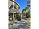 Elevated home exterior with wooden stairs leading to a dock at 3001 Buccaneer Rd, Isle of Palms, SC 29451
