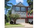 Two-story townhome with gray and red siding, two-car garage, and landscaping at 9120 Parlor Dr, Ladson, SC 29456