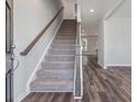 Modern entryway with carpeted stairs and luxury vinyl plank flooring at 111 Ashley Cove Way, Summerville, SC 29483
