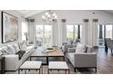 Spacious living room with hardwood floors, large windows, and comfortable seating at 66 Cooper St, Charleston, SC 29403