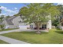 Two story house with front porch and attached garage at 124 Sweet Alyssum Dr, Ladson, SC 29456
