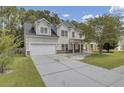 Two story house with front porch and attached garage at 124 Sweet Alyssum Dr, Ladson, SC 29456
