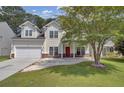 Two story house with front porch and attached garage at 124 Sweet Alyssum Dr, Ladson, SC 29456