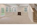 Spacious living room featuring a fireplace, carpet flooring, and access to a back patio at 116 Braxton Rd, Harleyville, SC 29448