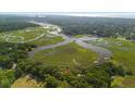 Aerial view showcasing home's waterfront location and marsh at 8541 Oyster Factory Rd, Edisto Island, SC 29438