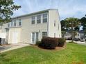 Rear view of tan house with private patio at 9019 Maple Grove Dr, Summerville, SC 29485