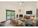 Living room with fireplace, wood floors, and access to screened porch at 2317 Tall Sail Dr # 1007 G, Charleston, SC 29414