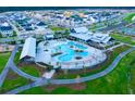 Aerial view of community pool with surrounding landscaping and a clubhouse at 400 Swaying Pine Ln, Summerville, SC 29486
