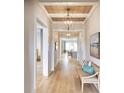 Light-filled entry hall with hardwood floors, bench seating, and views to the living area at 407 Swaying Pine Ln, Summerville, SC 29486