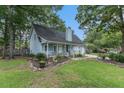 Light blue house with a white porch, two-car garage, and landscaped yard at 137 Fox Chase Dr, Goose Creek, SC 29445
