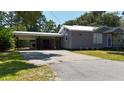 Home features a carport for covered parking and a spacious driveway at 110 Groves St, Walterboro, SC 29488