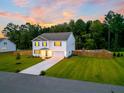 Aerial view of house, driveway, and front yard at 1136 Wading Point Blvd, Huger, SC 29450