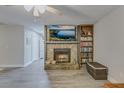 Living room with a stone fireplace, built-in shelving, and hardwood floors at 1213 Westward Dr, Goose Creek, SC 29445