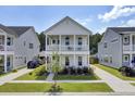 Two-story home with white siding, front porch, and landscaped yard at 117 River Wind Way, Summerville, SC 29485