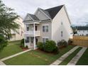 Two-story house with a landscaped yard, driveway, and attached garage at 131 Tin Can Aly, Summerville, SC 29483