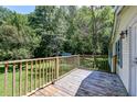 Wooden deck overlooking a backyard with trees and a shed at 121 Paisan Rd, Summerville, SC 29483