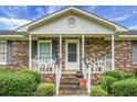 Brick home with front porch and white railing at 2363 Ranger Dr, Cross, SC 29436