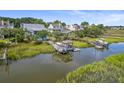 Aerial view of waterfront homes with private docks and boats at 1374 Black River Dr, Mount Pleasant, SC 29466