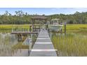 Private boat dock with a covered gazebo and a small motorboat at 1374 Black River Dr, Mount Pleasant, SC 29466
