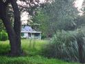 A damaged house exterior with overgrown yard at 1132 Brownswood Rd, Johns Island, SC 29455