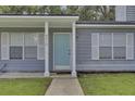 Gray house exterior with a light blue front door and white shutters at 9510 Raven Dr, Ladson, SC 29456