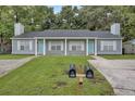 Front view of a gray duplex with two light blue doors at 9510 Raven Dr, Ladson, SC 29456