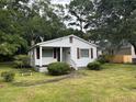 Charming one-story home with white siding and maroon shutters at 1032 Greenhill Rd, Charleston, SC 29412
