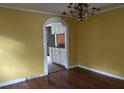 Bright dining room with hardwood floors and an arched pass-through to the kitchen at 1032 Greenhill Rd, Charleston, SC 29412