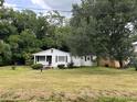 Charming one-story home with white siding and maroon shutters at 1032 Greenhill Rd, Charleston, SC 29412