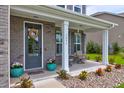 Front porch with seating and potted plants at 1255 Hammrick Ln, Johns Island, SC 29455