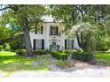 Two story white house with a brick pathway at 219 Rigby St, Reevesville, SC 29471