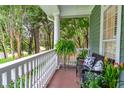 Relaxing front porch with white columns and lush greenery at 4714 Gold Cup Ln, Hollywood, SC 29449