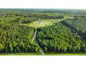 Aerial view of a house and expansive property with lush greenery at 7335 Dorange Rd, Reevesville, SC 29471