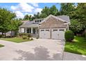 One-story home with light green exterior, stone accents, and two-car garage at 140 Tortoise St, Summerville, SC 29483