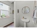 Small powder room with pedestal sink and decorative mirror at 315 Black Birch Dr, Summerville, SC 29486