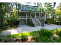 Two story home with a landscaped lawn and driveway at 3350 Seabrook Island Rd, Seabrook Island, SC 29455