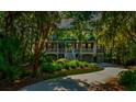 Two story home with a landscaped lawn and driveway at 3350 Seabrook Island Rd, Seabrook Island, SC 29455
