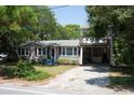 Charming two-story home with a large yard and driveway at 1302 E Ashley Ave, Folly Beach, SC 29439