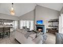 Spacious living room with vaulted ceiling, fireplace, and access to a deck at 202 Mariners Cay Dr, Folly Beach, SC 29439