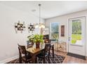 Bright dining area with glass-top table, wine rack, and access to back patio at 147 Trailview Ln, Summerville, SC 29486