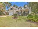 House exterior with beige siding, green shutters, and a covered porch at 802 Long Drive Rd, Summerville, SC 29485