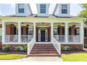 Two-story home with a welcoming front porch and brick facade at 3397 Shagbark Cir, Mount Pleasant, SC 29466